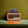 Brown vintage portable radio with solar panel and antenna, an old-fashioned rechargeable outdoor radio details Picture